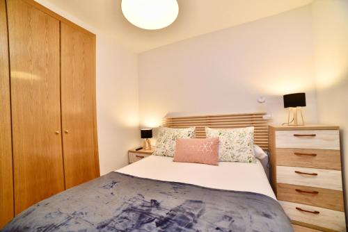 a bedroom with a bed and a wooden cabinet at El balcón de la inspiración en plena natura HUT-8434 in Encamp