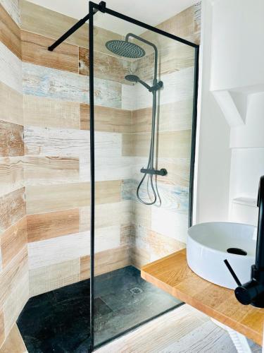 a glass shower in a bathroom with a sink at Ventana a la Ría in Ferrol