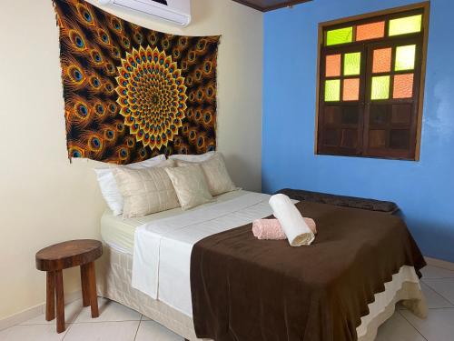 a bedroom with a bed and a window at Pousada do Tom in Lençóis
