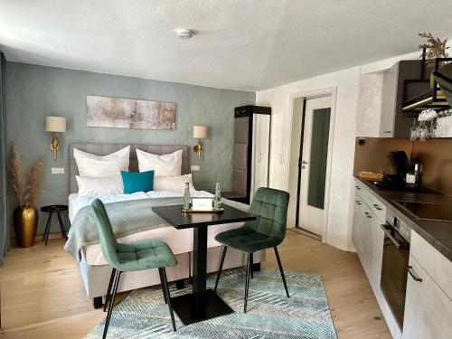 a bedroom with a bed and a table and chairs at Rotmain Apartments in Bayreuth