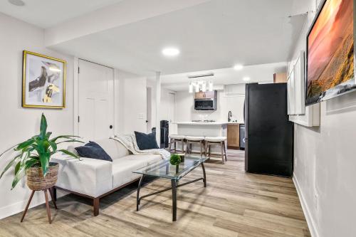 a living room with a couch and a table at BRAND NEW Private and Modern 2BR Unit in Minneapolis