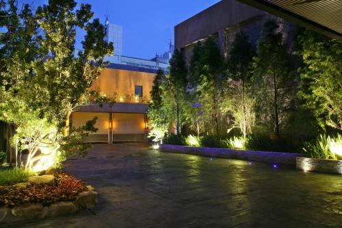 a courtyard with a building and trees and lights at Han Guan Motel in Taichung