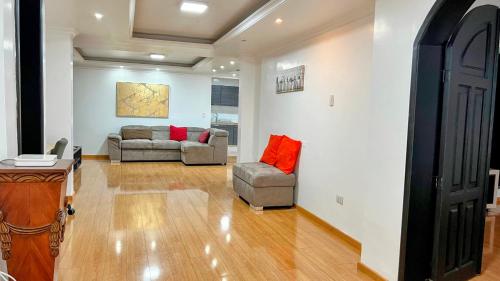 a living room with a couch and a chair at Edificio Tofino in Quito