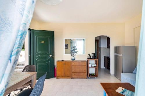 a kitchen with a green door and a refrigerator at Nice seaview balcony Porlamar Home 155 in Glyfada