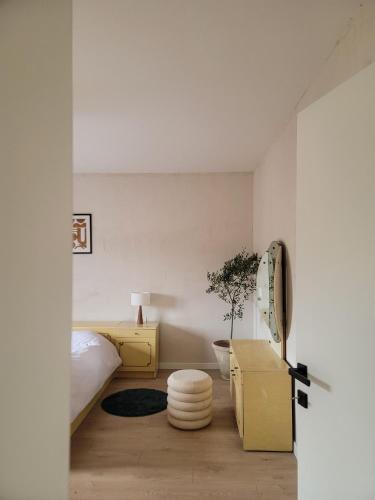 a bedroom with a bed and a table and a stool at Casa L in Ulcinj