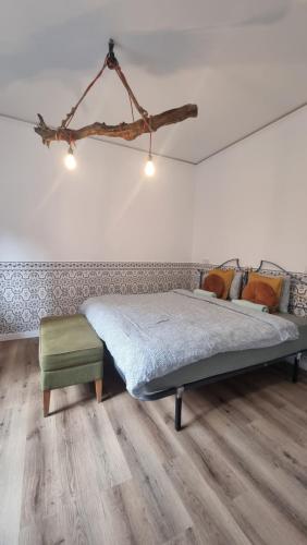 - une chambre avec un lit et un tabouret vert dans l'établissement Happen!ng, à Faro