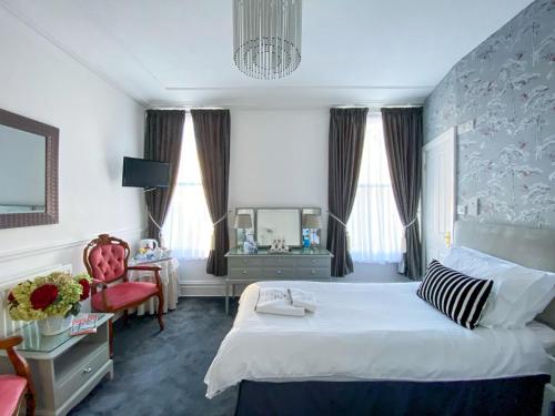 a hotel room with a bed and a chair at Number 10 Bed & Breakfast in Keswick