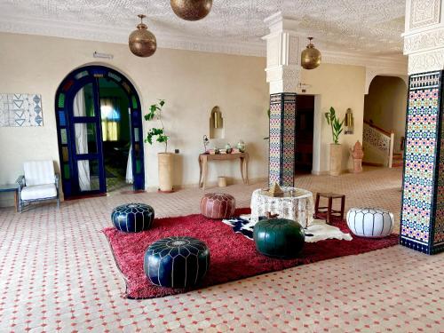 a room with many large spheres on a red rug at Dar Morocco in Merzouga