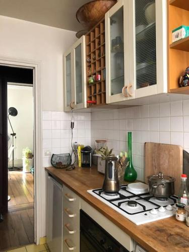 une cuisine avec une cuisinière et un comptoir dans l'établissement A haven of peace in Pigalle, à Paris