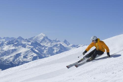 a man is skiing down a snow covered slope at Aktiv- und Genusshotel Alpenblick in Fiesch