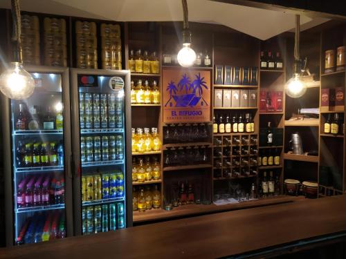 a bar with a lot of bottles of alcohol at Hotel Campestre El Refugio in Guaduas