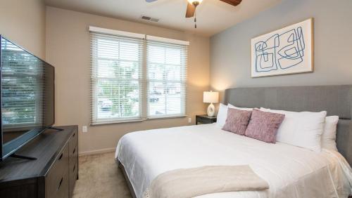 1 dormitorio con 1 cama grande y TV de pantalla plana en Landing Modern Apartment with Amazing Amenities (ID7805X76), en Huntsville