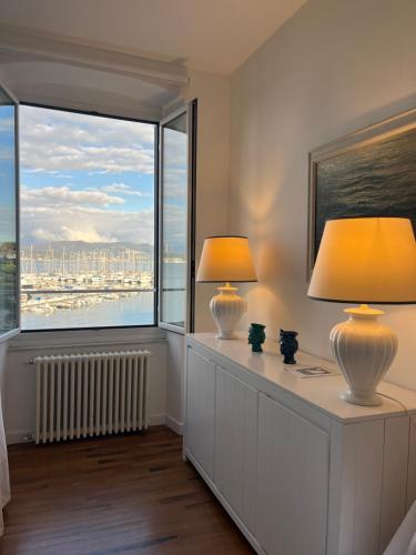 two lamps on a dresser in a room with a window at About Italy Holiday Rooms and Apartments in Portovenere