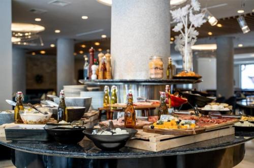 a buffet line with food and drinks on a table at Kraljevi Konaci Olja in Zlatibor