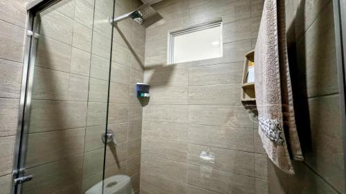 a bathroom with a shower stall and a toilet at Edificio Tofino in Quito