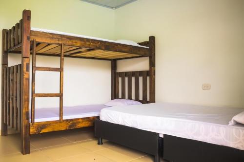 a bedroom with two bunk beds in a room at Hotel Campestre El Refugio in Guaduas