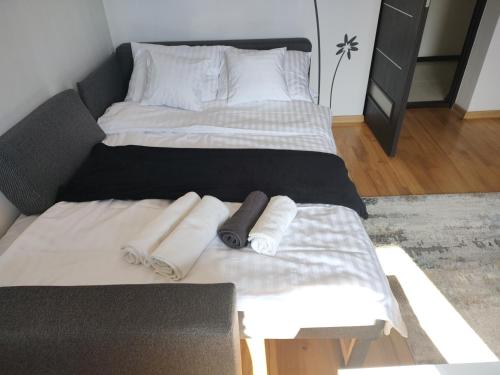 a bed with towels on it in a room at U Zajączka in Busko-Zdrój