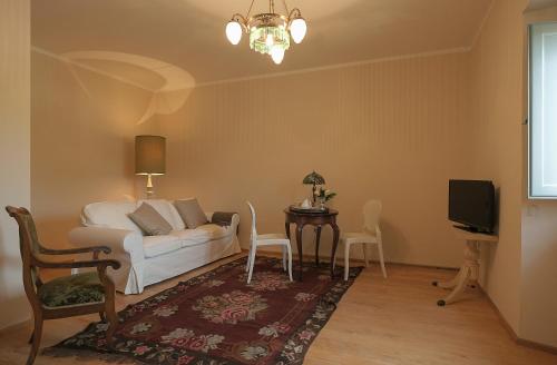a living room filled with furniture and a tv at B&B Palazzo Mattei in Novafeltria