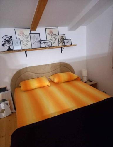 a bedroom with a bed with two pillows on it at tabiacondo in Ljubuški