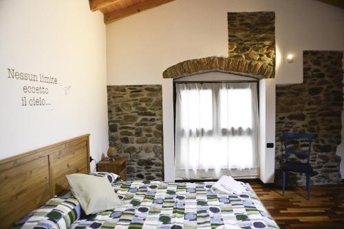 a bedroom with a bed in front of a window at A casa di Sole Brovello in Brovello-Carpugnino