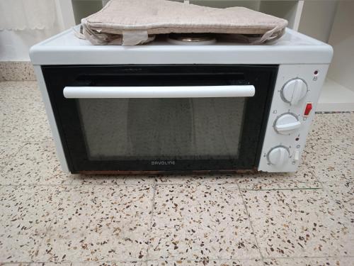 a white toaster oven sitting on a counter at Azalea garden appartment with mountain view in Kremasti