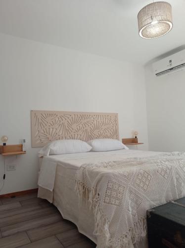 una camera bianca con un letto con copriletto bianco di La Vasca a Manuel B. Gonnet