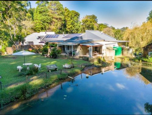 a house with a pond in front of it at One on Old Main, Unit 5 in Hillcrest