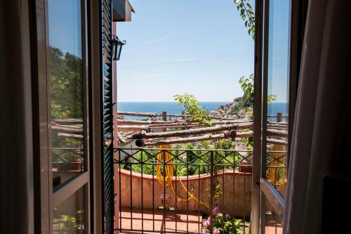 an open window with a view of the ocean at Casa Ferrigno in Maiori