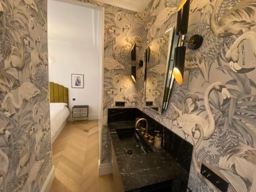 a bathroom with a sink and a room with a bed at Luxury apartment in Gran Vía in Madrid