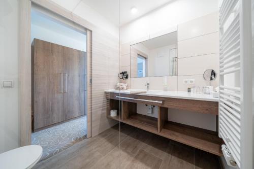 a bathroom with a sink and a mirror at Landhotel Berger in Eben im Pongau