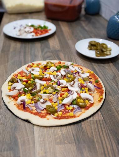 a pizza sitting on top of a wooden table at County Hotel in Helensburgh