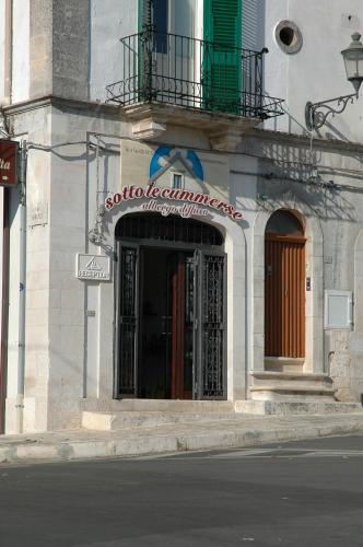 a building with a sign on the side of a street at Albergo Diffuso Sotto le Cummerse in Locorotondo