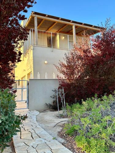 a house with a walkway in front of it at negevibe in Midreshet Ben Gurion