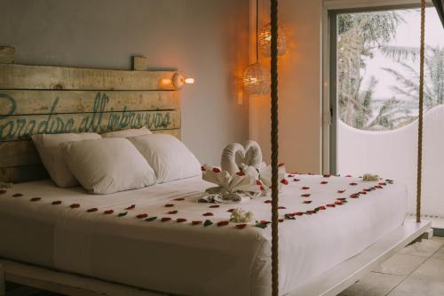 a bedroom with a bed with a flower arrangement on it at 40 Cañones in Mahahual