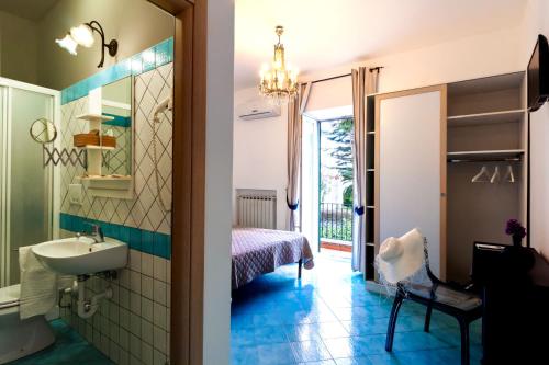 a bathroom with a sink and a mirror at Don Giorgio Rooms in Ischia