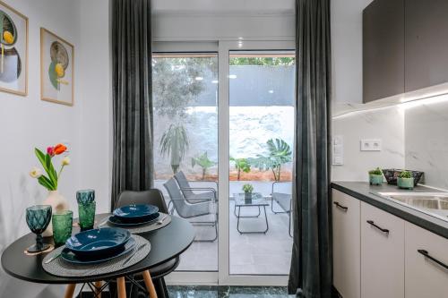 a kitchen with a table and a dining room at Place to be Athens apartment in Athens