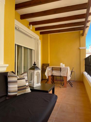 a living room with a couch and a table at Casa Amarela Guesthouse, Algorfa in Algorfa