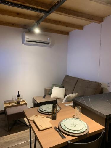 a living room with two tables and a couch at Tiny House no Olival in Pelotas