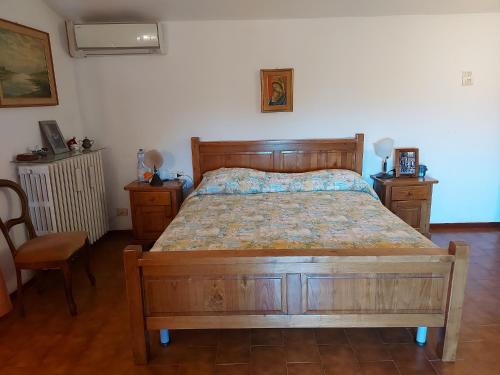 a bedroom with a wooden bed and two night stands at Villa Pilar in Toscana con piscina ultrapanoramica in Montevettolini