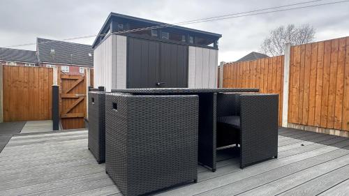 a patio with a table and speakers on a deck at Home Sweet Home (Townhouse) in Manchester