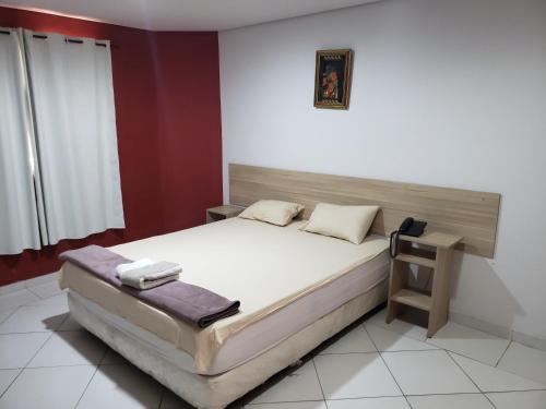 a bedroom with a large bed and a table at HOTEL SANTA MARIA in Asuncion
