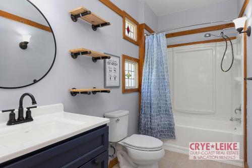 a bathroom with a sink and a toilet and a mirror at Riverwood Lodge in Foley