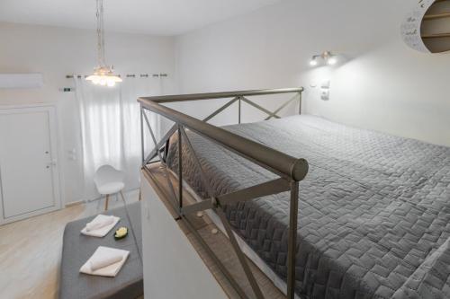 a bedroom with a bed with a metal frame at Sunny Studios 2 in Mángana