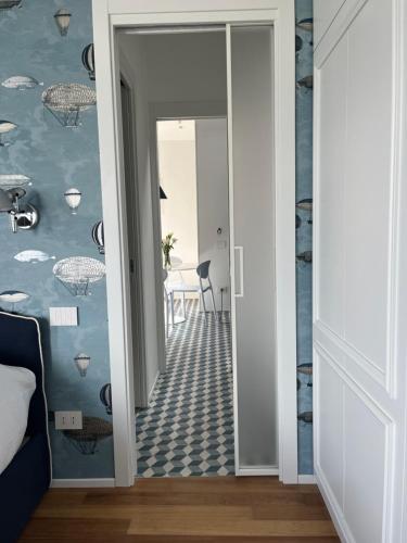 a hallway with a door leading into a room with blue walls at About Italy Holiday Rooms and Apartments in Portovenere
