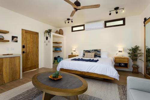 a bedroom with a bed and a coffee table at Mantra Baja, Boutique Hotel in Los Barriles