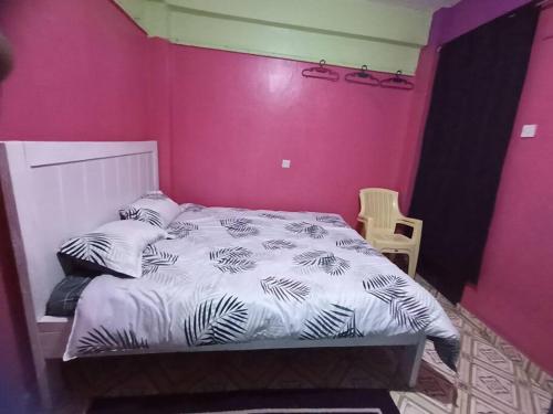una camera con letto e parete rosa di Wamusa Homes at Chaka a Kiganjo