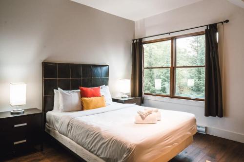 a bedroom with a large bed and a window at Captivating view of Lake Superieur in Lac-Superieur