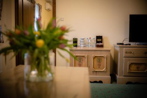 a vase of flowers sitting on top of a table at Hotel Górski in Wolbórz