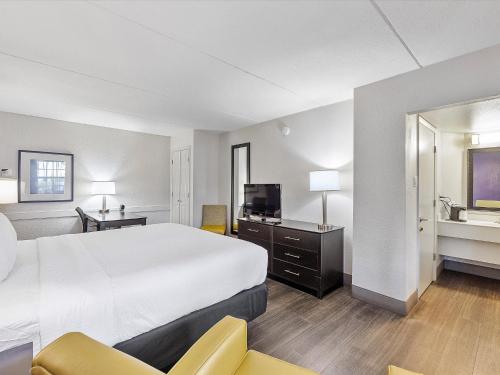 a hotel room with a large bed and a television at La Quinta Inn by Wyndham Miami Airport North in Miami