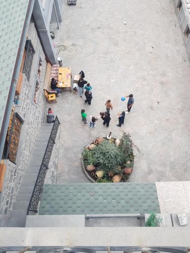 an overhead view of a group of people in a courtyard at Rubin Hotel in Goris